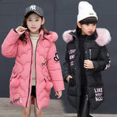 Girls wearing long puffer coats, one pink and one black, with faux fur hoods and text accents.