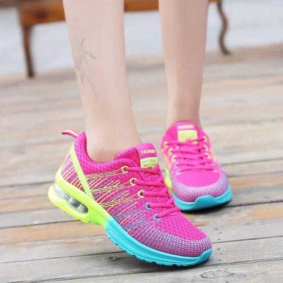 Bright pink mesh sneakers with neon green and blue sole, lightweight athletic fit