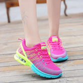 Bright pink mesh sneakers with blue and neon yellow details, breathable athletic fit