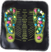 Black acupressure massage mat with colorful raised nodes, foot reflexology chart design