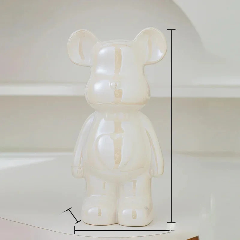 Glossy cream ceramic bear figurine with measurement lines, minimalist decor setting
