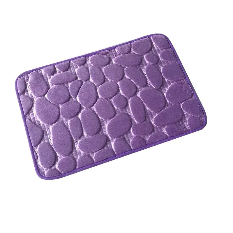 Plush purple bath mat with pebble pattern, soft fabric, rectangular shape, modern style