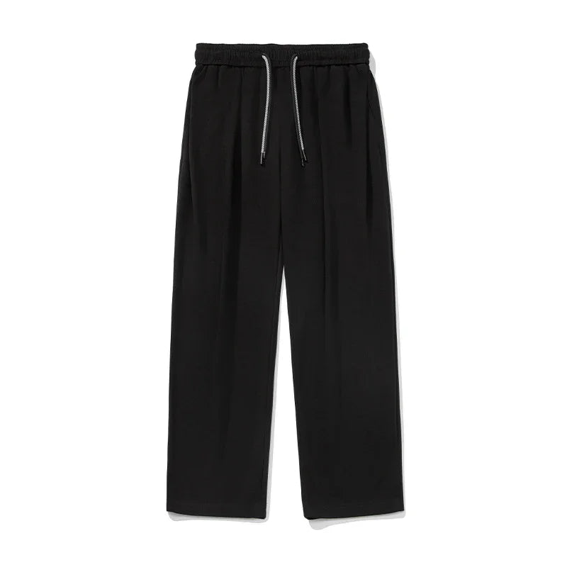Black wide-leg streetwear pants with elastic waistband and drawstring, relaxed fit
