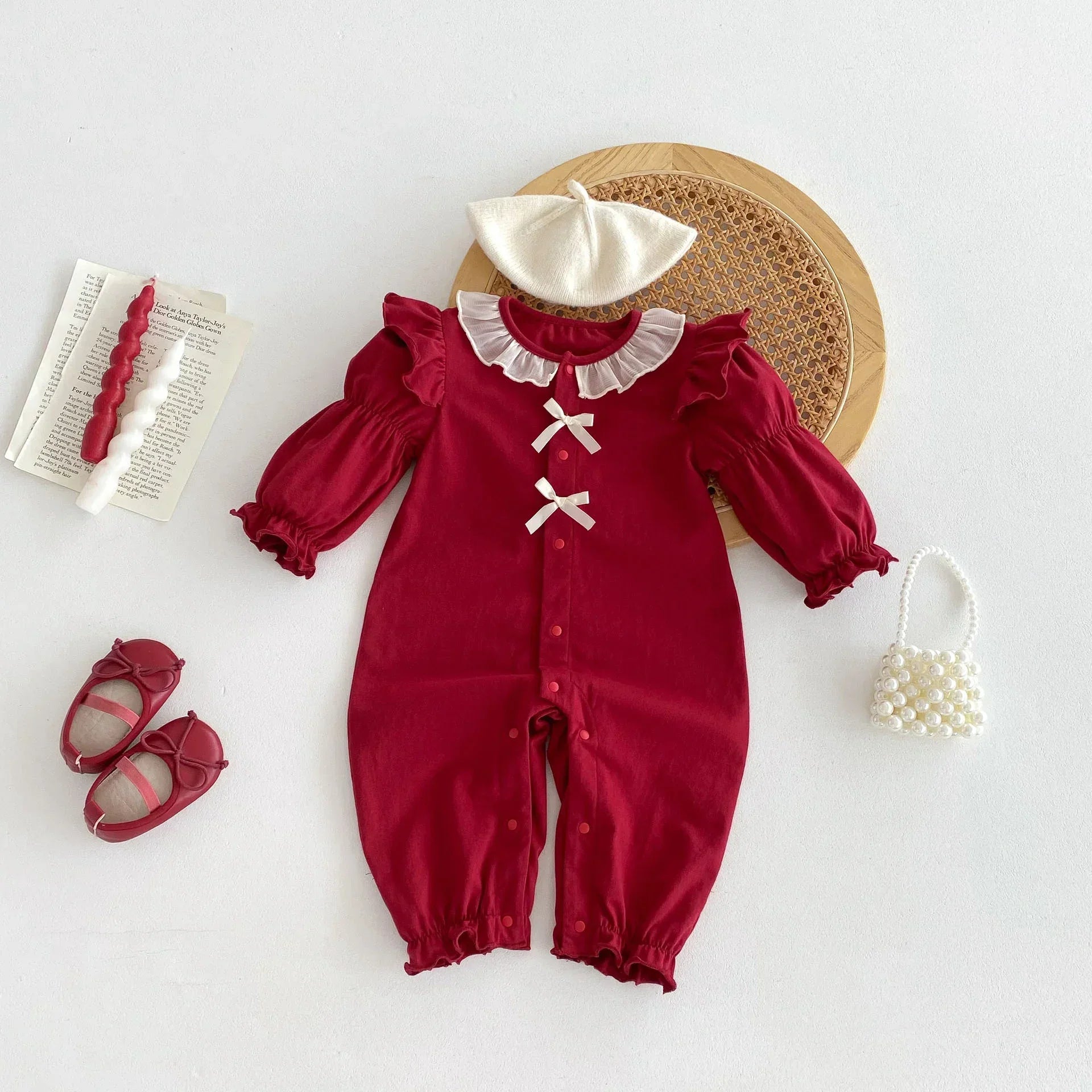 Red long-sleeve baby romper with ruffled collar, lace bows, and elastic cuffs, paired with matching beret and shoes