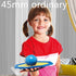 Girl in a red short sleeve colorblock shirt, holding a blue and yellow toy indoors.