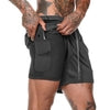 Black athletic shorts with side pocket, zipper detail, and relaxed fit for streetwear style