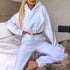 Woman wearing white cropped hoodie and joggers loungewear set, relaxed fit, fleece material.
