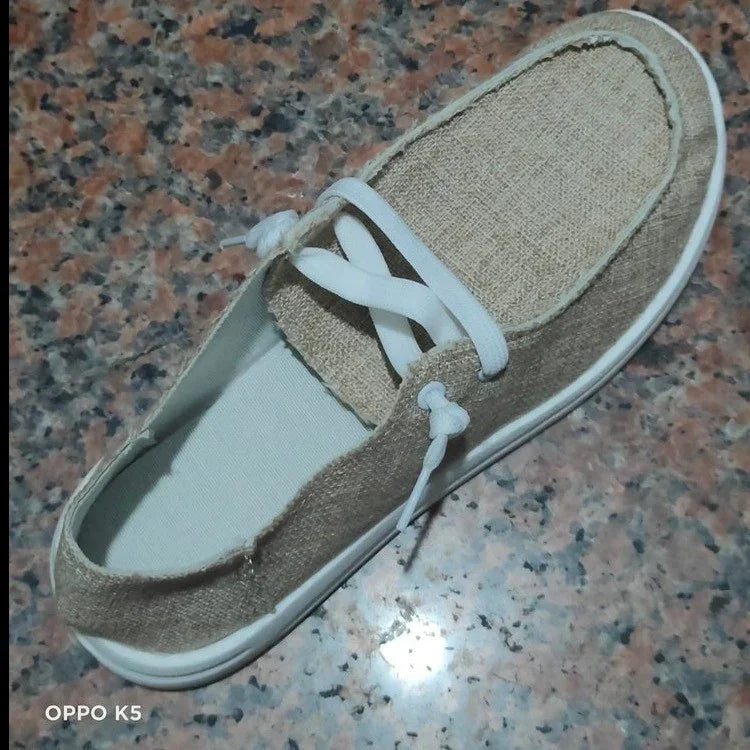 Beige canvas casual loafer with white laces and sole, minimalist streetwear style