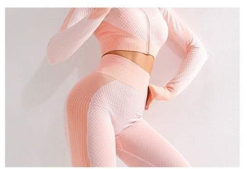 Woman wearing pink textured seamless long sleeve crop top and high-waist leggings set