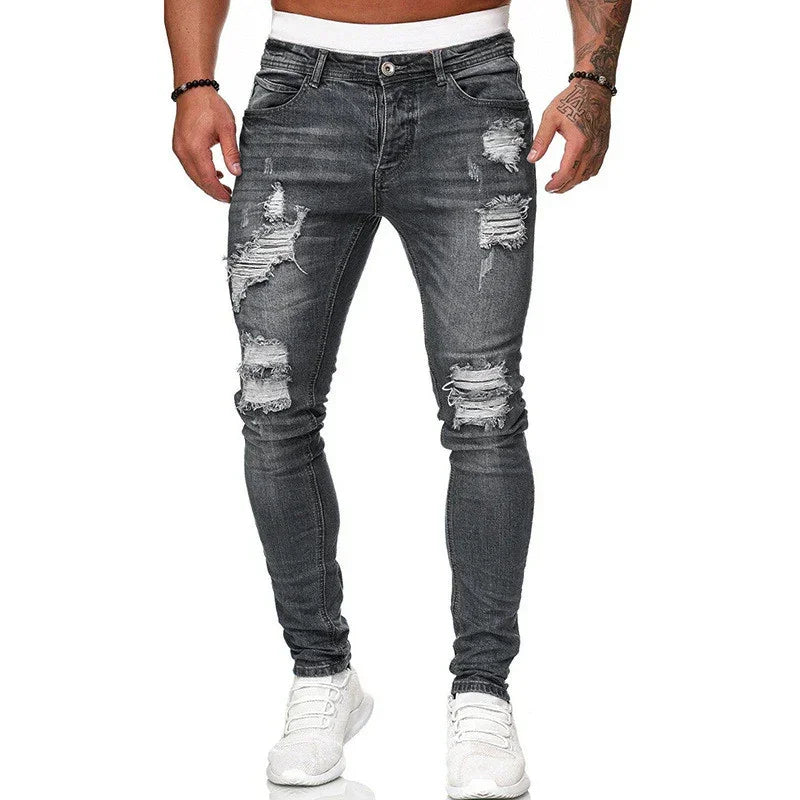 Men's skinny fit distressed grey denim jeans with heavy rips and faded wash