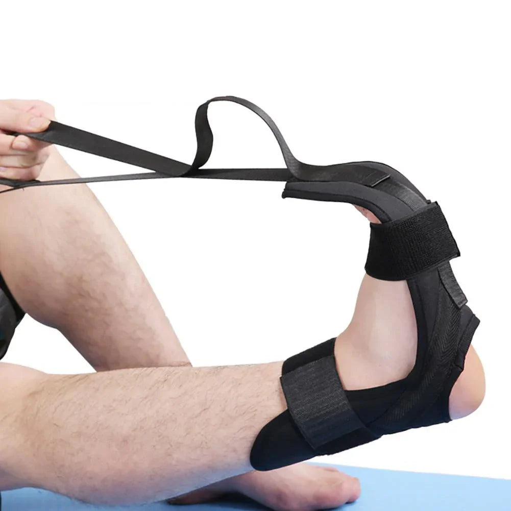 Black adjustable foot and ankle stretching strap with secure velcro fit, shown in use