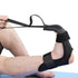 Black adjustable foot and ankle stretching strap with secure velcro fit, shown in use