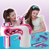 Girls using a pink and white automatic hair braiding tool with colorful hair accessories on table.
