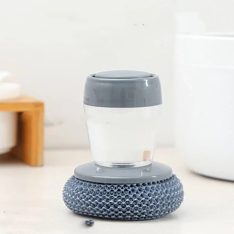 Grey and clear scrubber with textured base, soft plastic material, compact ergonomic fit