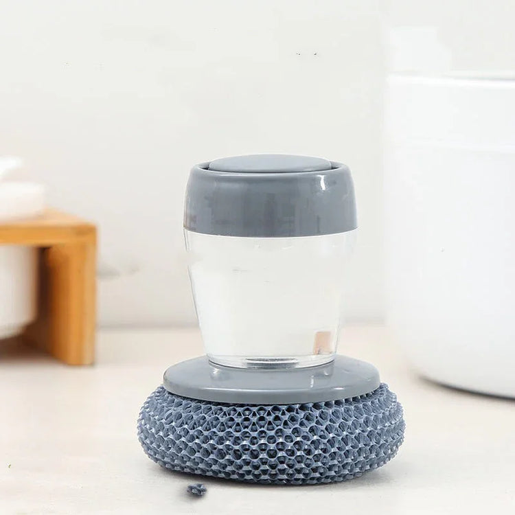Grey and clear scrubber with textured base, soft plastic material, compact ergonomic fit