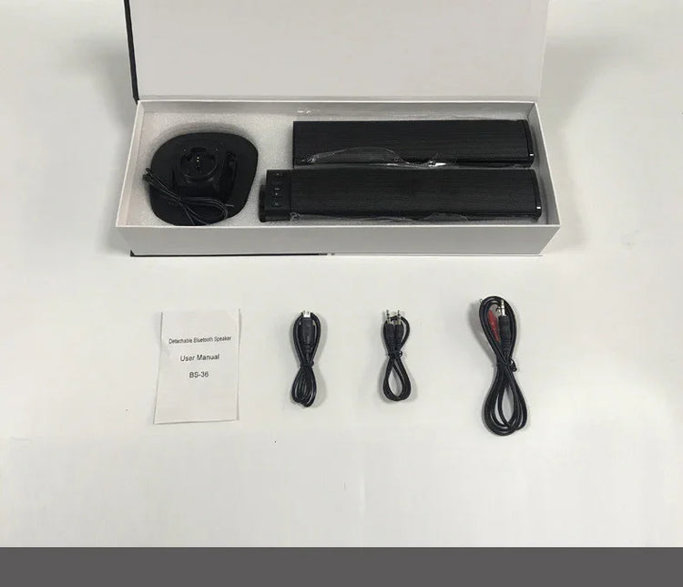 Black detachable Bluetooth speaker set with accessories, user manual, and cables on white background