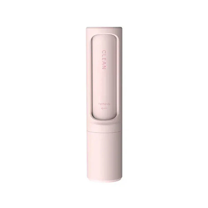Minimalist pink cleaning brush with sleek cylindrical design, compact plastic body