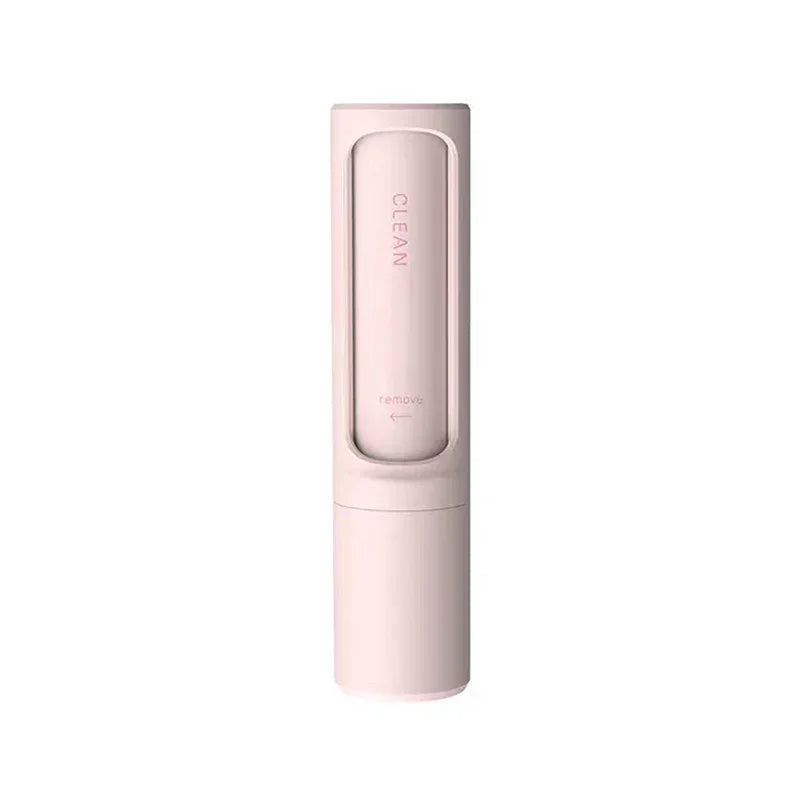 Minimalist pink cleaning brush with sleek cylindrical design, compact plastic body