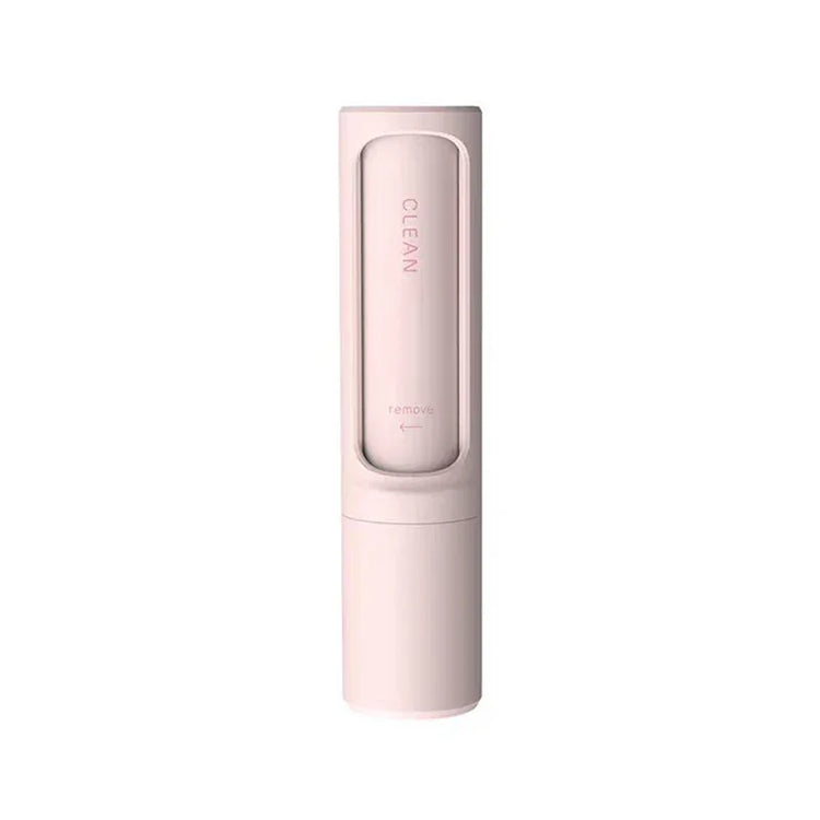 Minimalist pink cleaning brush with sleek cylindrical design, compact plastic body