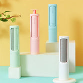 Pastel lint removers with fabric brushes in green, pink, blue, and white displayed on blocks