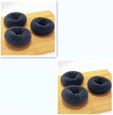 Three black mesh knit scrunchies with a thick texture on a wooden surface