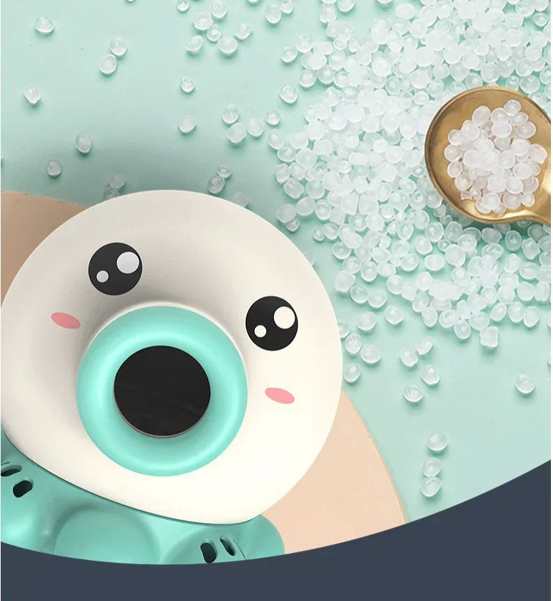 Closeup of a cute teal and white cartoon toy with plastic pellets on pastel background.