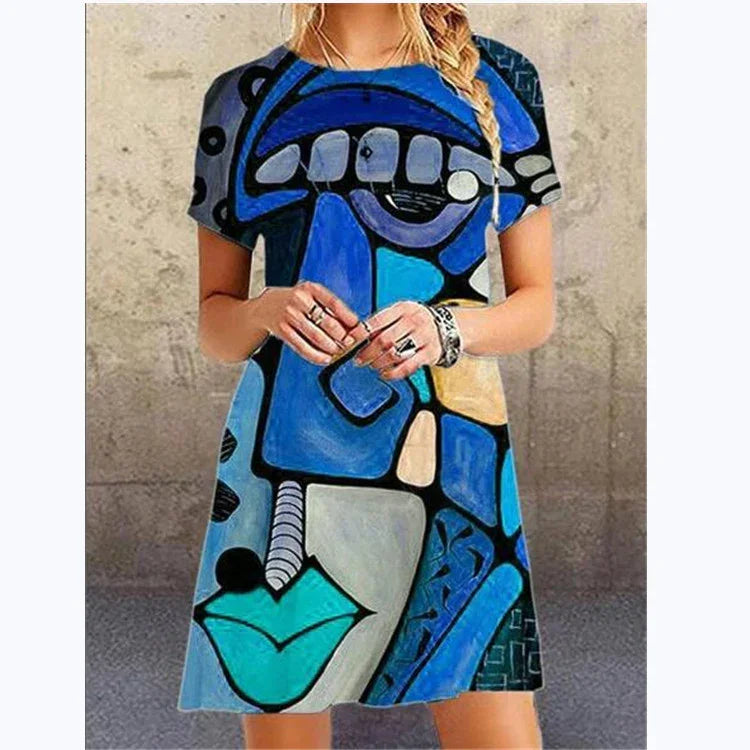 Woman wearing short sleeve loose fit dress with bold blue abstract geometric print