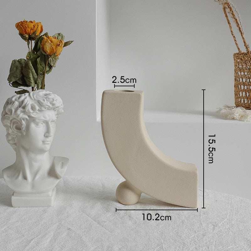 Minimalist off-white ceramic vase with geometric curved design, matte finish, measurements visible