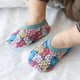 Colorful cartoon animal print toddler slippers with teal trim, soft fabric, snug fit