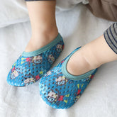 Baby feet in blue mesh slip-on socks with cartoon animal print, soft snug fit