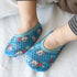 Baby feet in blue mesh slip-on socks with cartoon animal print, soft snug fit