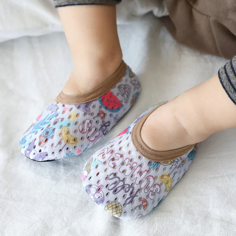 Child wearing lightweight mesh slip-on shoes with colorful cartoon prints and brown trim