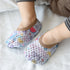 Child wearing lightweight mesh slip-on shoes with colorful cartoon prints and brown trim