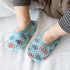 Baby wearing light blue mesh slip-on socks with colorful fish print, soft fabric, snug fit