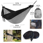 Lightweight black and gray hammock with straps, compact storage bag, outdoor setup.