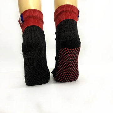 Black and red non-slip socks with grip dots, snug fit, mid-calf length, knit material