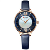 Elegant wristwatch with blue leather strap, gold case, and dark blue dial with roman numerals