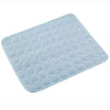 Light blue quilted mat with circular pattern, soft fabric, rounded edges, non-slip design for kitchen or bathroom use