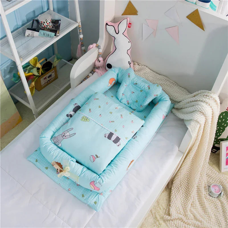 Light blue cotton baby bedding set with playful animal prints and soft padded edges