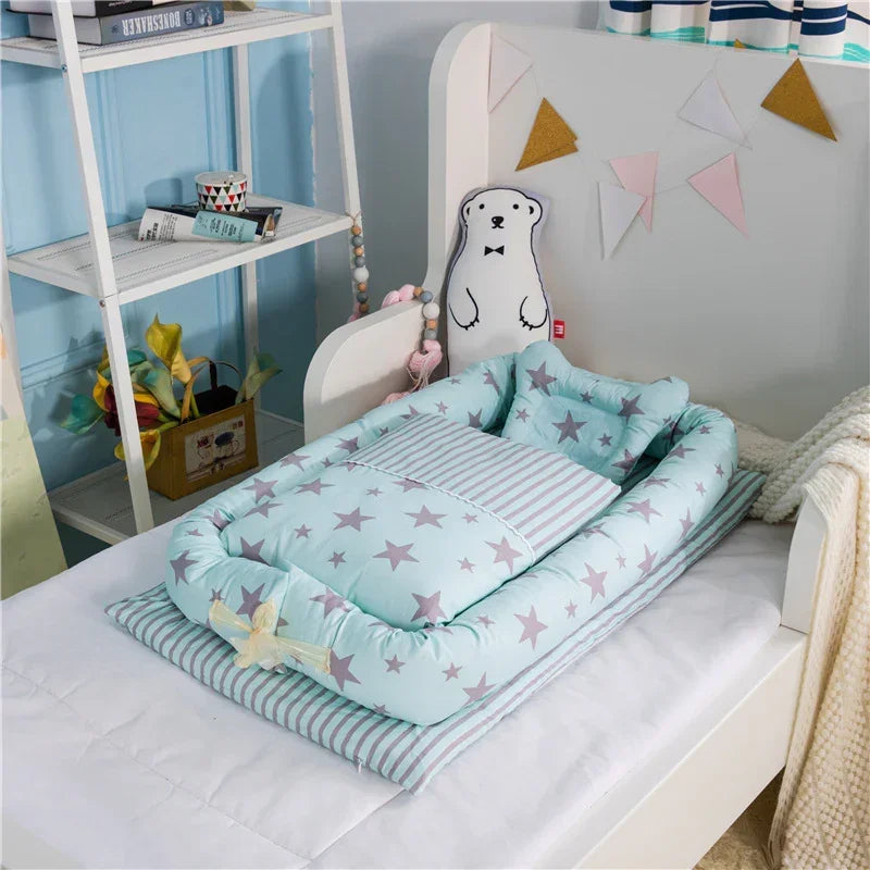 Light blue star-patterned baby nest with striped pillow and bedding on a child's bed