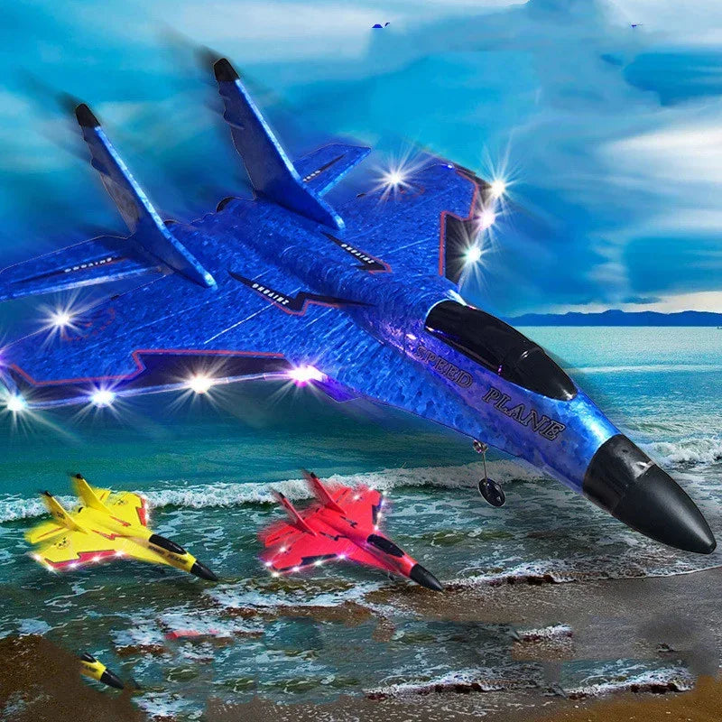 Colorful blue, red, and yellow toy planes with LED lights flying over a beach shoreline.