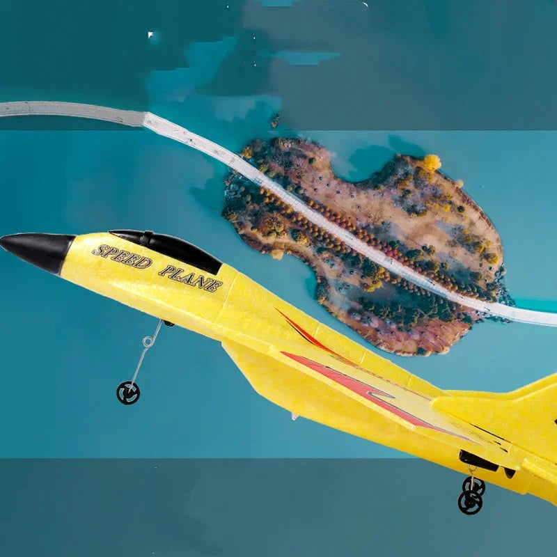 Yellow foam speed plane toy with red accents flying over blue water and small island.
