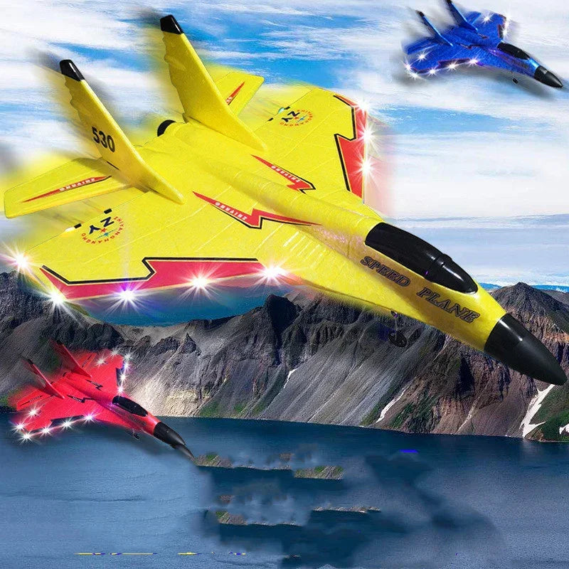 Colorful foam glider planes in yellow, red, and blue with LED lights flying above a mountain lake.