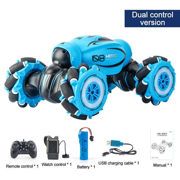 Bright blue and black remote control stunt car with large rugged wheels, shown with controller, watch remote, battery, USB cable, and manual.
