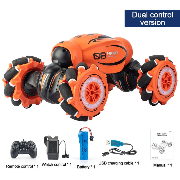 Orange and black remote control stunt car with large wheels, includes controller, watch remote, battery, USB cable, and manual.