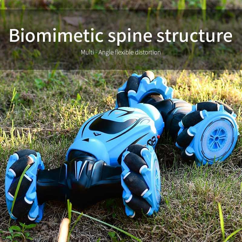 Blue futuristic toy car with biomimetic spine structure on grassy ground
