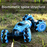 Blue futuristic toy car with biomimetic spine structure on grassy ground