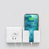 White wall-mounted charging holder with smartphone in minimalist plastic cradle