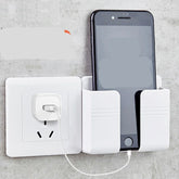 White wall-mounted phone holder with smartphone charging near power outlet