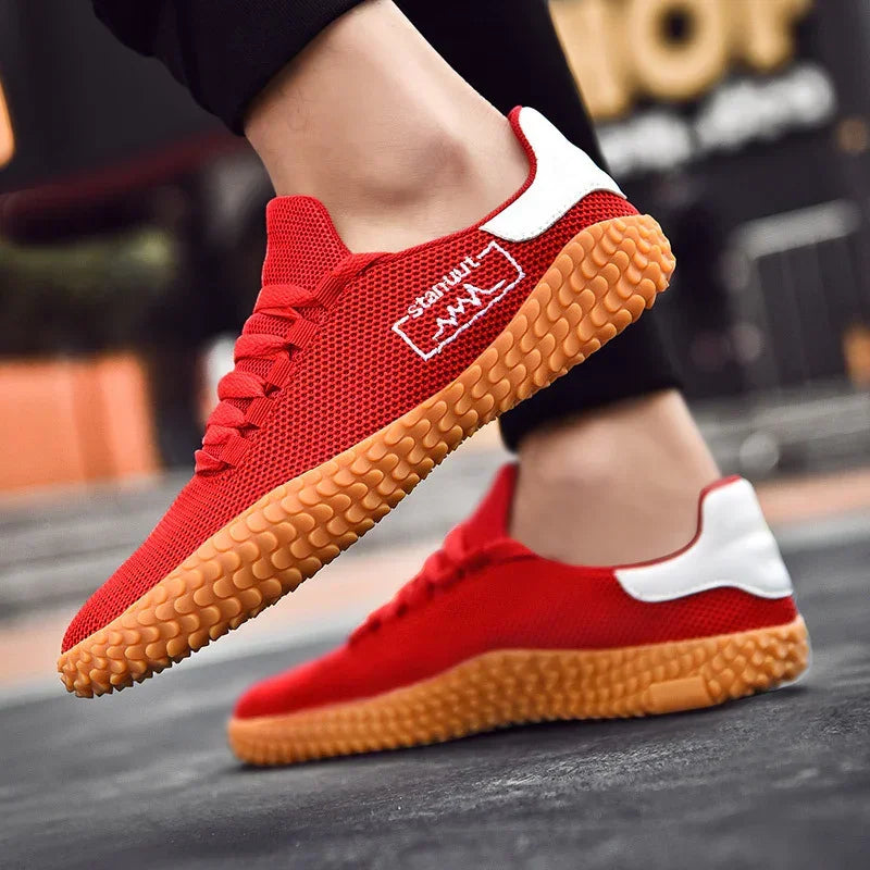Red mesh low-top sneakers with gum sole, white heel accent, sporty casual fit